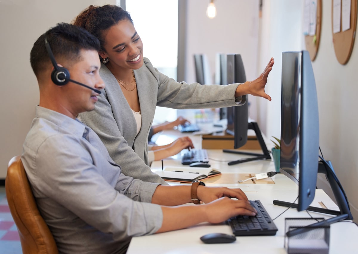 shot-of-two-call-centre-agents-working-together-on-2023-11-27-05-06-06-utc-min