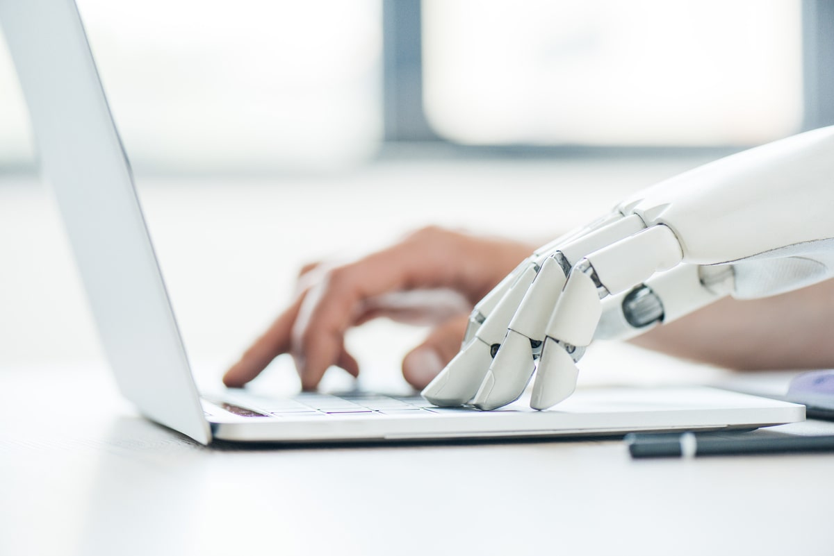 selective-focus-of-human-and-robot-hands-typing-on-2023-11-27-05-28-22-utc-min